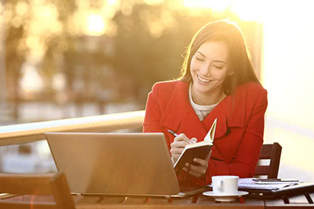 Versicherungen für Existenzgründer - Junge lächelnde Journalistin