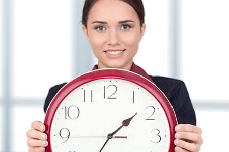 Garderobenversicherung - Eine lächelnde Frau hat eine Uhr in der Hand
